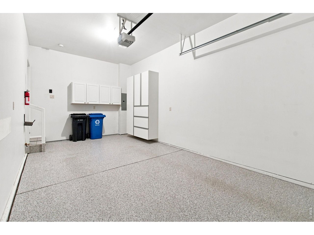 Property Photo 30 Finished attached garage with epoxy-coated floor, built-in storage and additional overhead storage.