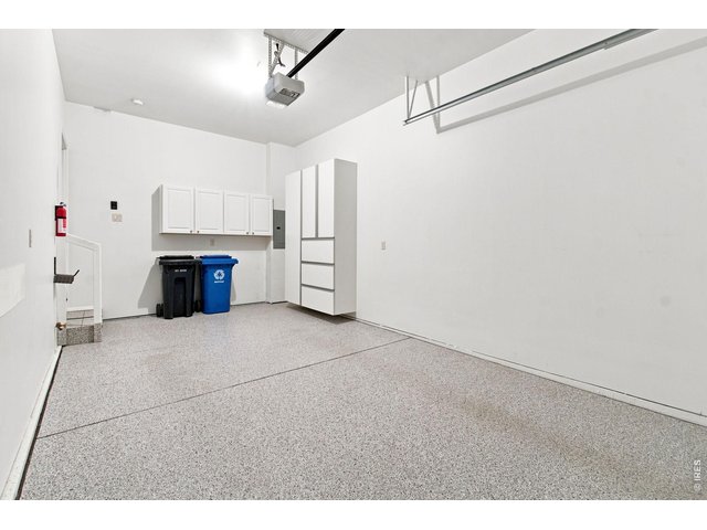 Property Photo 30 Finished attached garage with epoxy-coated floor, built-in storage and additional overhead storage.