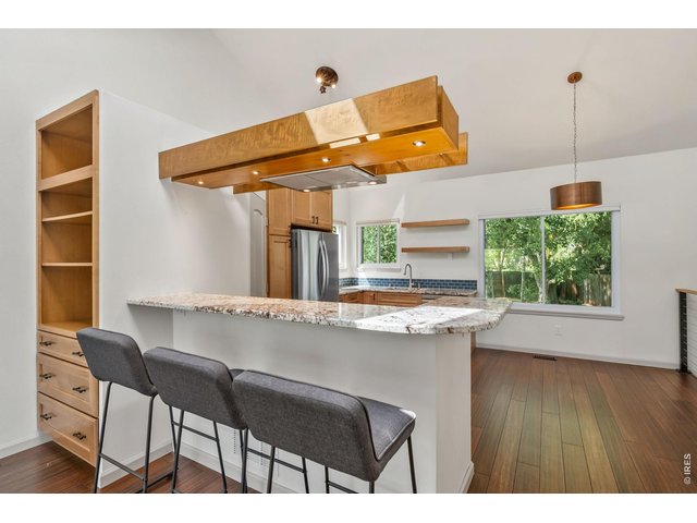 Property Photo 5 Amazing updated kitchen with stone countertops, stainless appliances, and floating range hood.