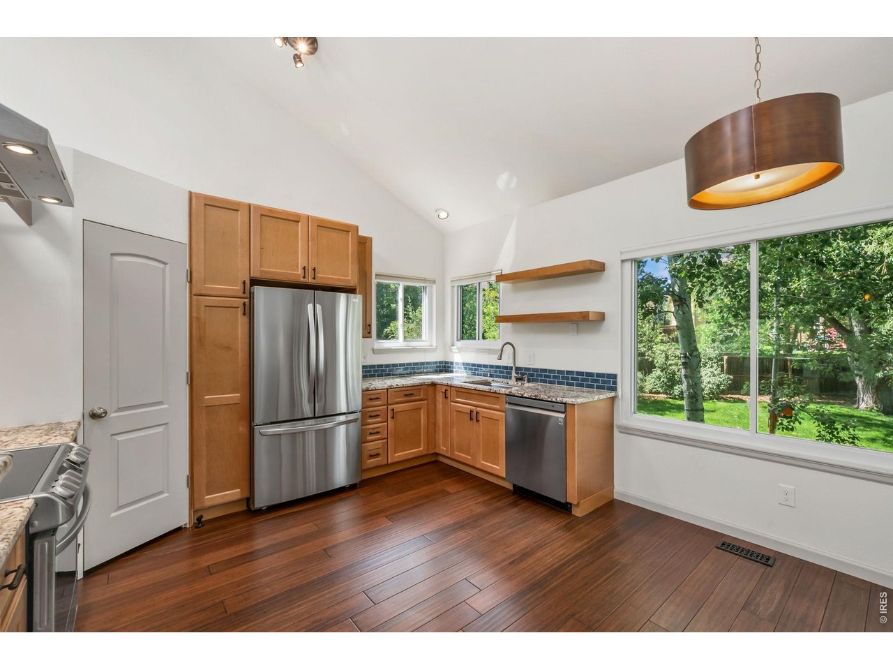 Property Photo 6 Amazing updated kitchen with stone countertops, stainless appliances, and floating range hood.