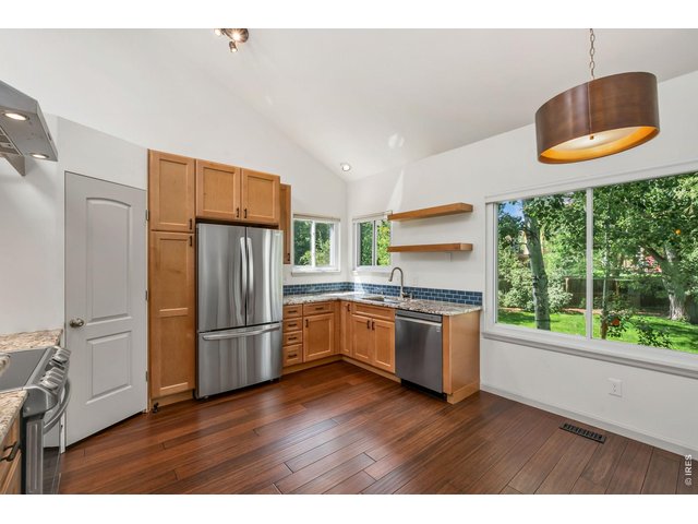 Property Photo 6 Amazing updated kitchen with stone countertops, stainless appliances, and floating range hood.