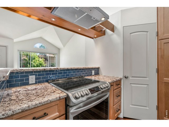 Property Photo 8 Amazing updated kitchen with stone countertops, stainless appliances, and floating range hood.