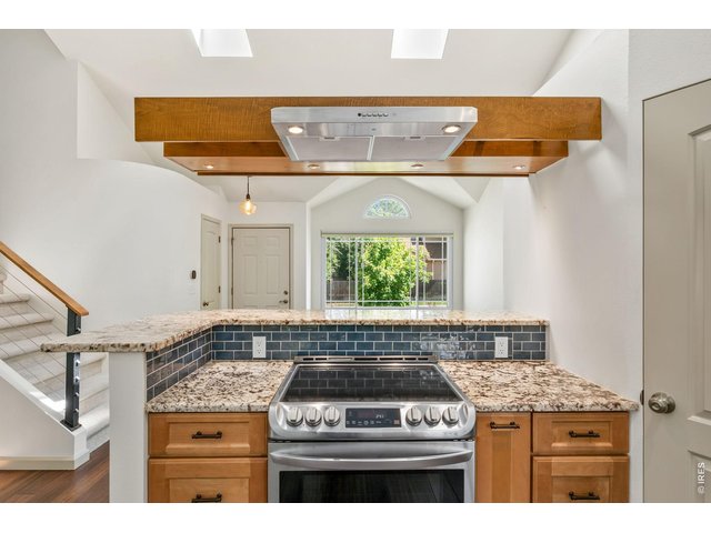 Property Photo 7 Amazing updated kitchen with stone countertops, stainless appliances, and floating range hood.
