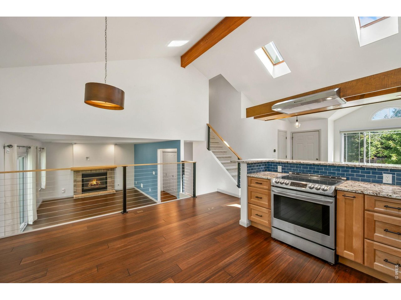 Property Photo 3 Amazing updated kitchen with stone countertops, stainless appliances, and floating range hood.