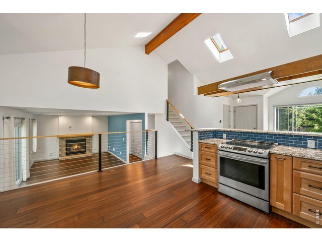 Property Photo 3 Amazing updated kitchen with stone countertops, stainless appliances, and floating range hood.