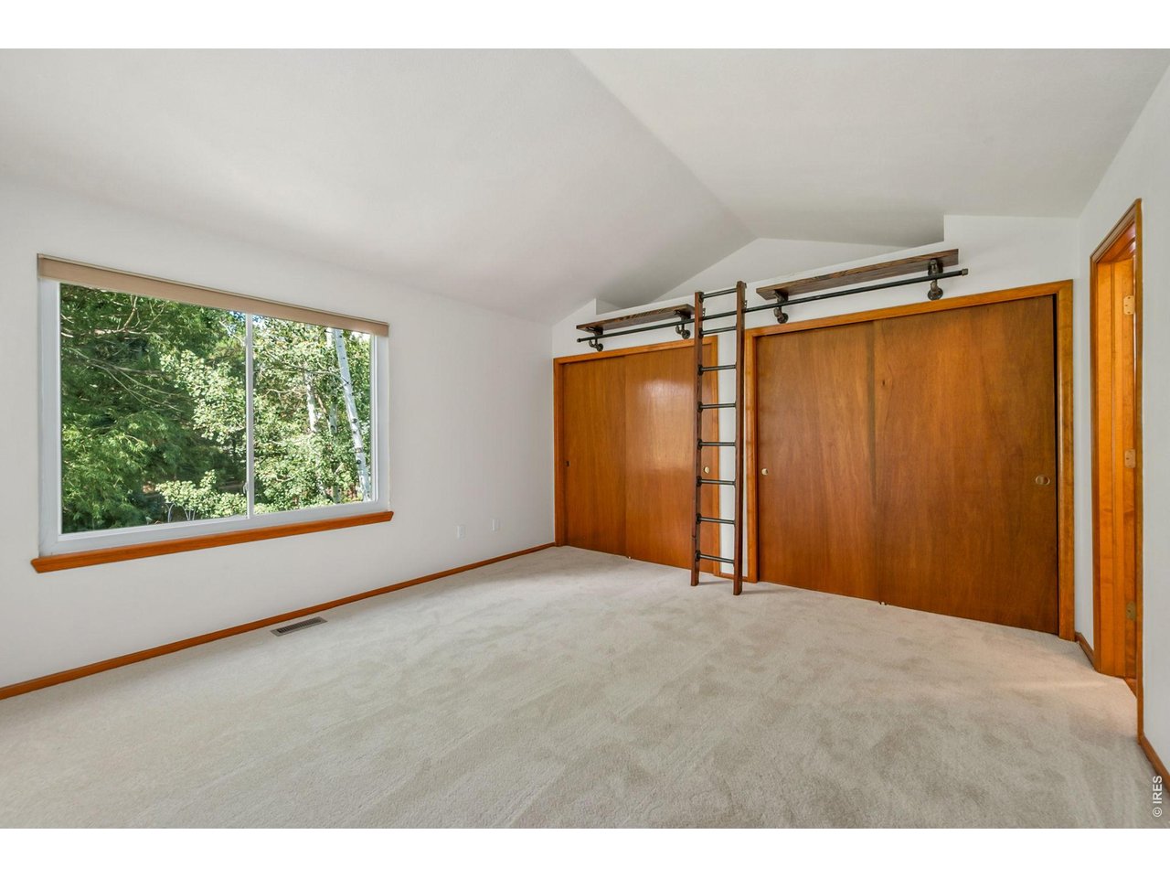 Property Photo 19 Formal primary bedroom with vaulted ceilings