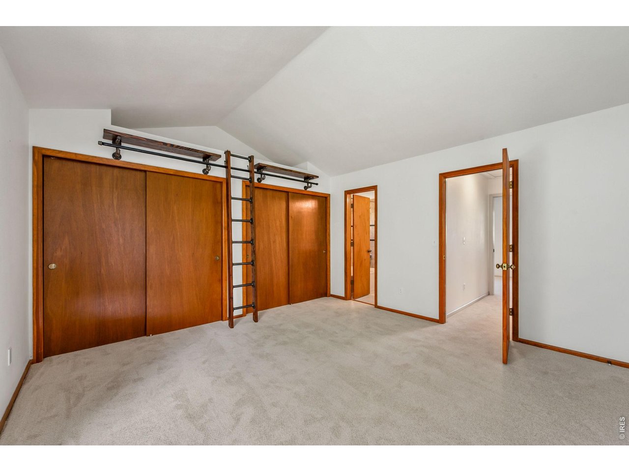 Property Photo 18 Formal primary bedroom with vaulted ceilings