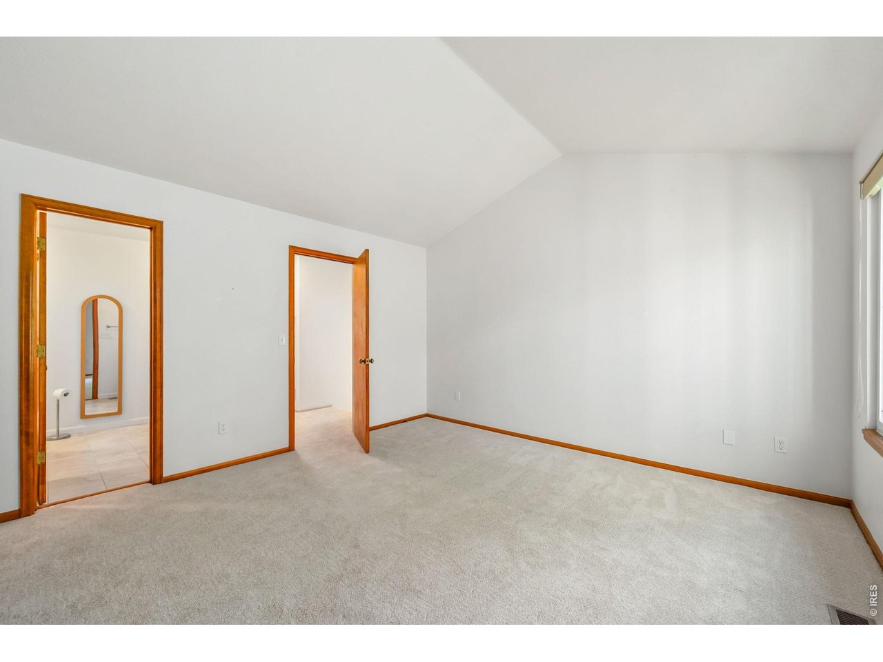 Property Photo 20 Formal primary bedroom with vaulted ceilings