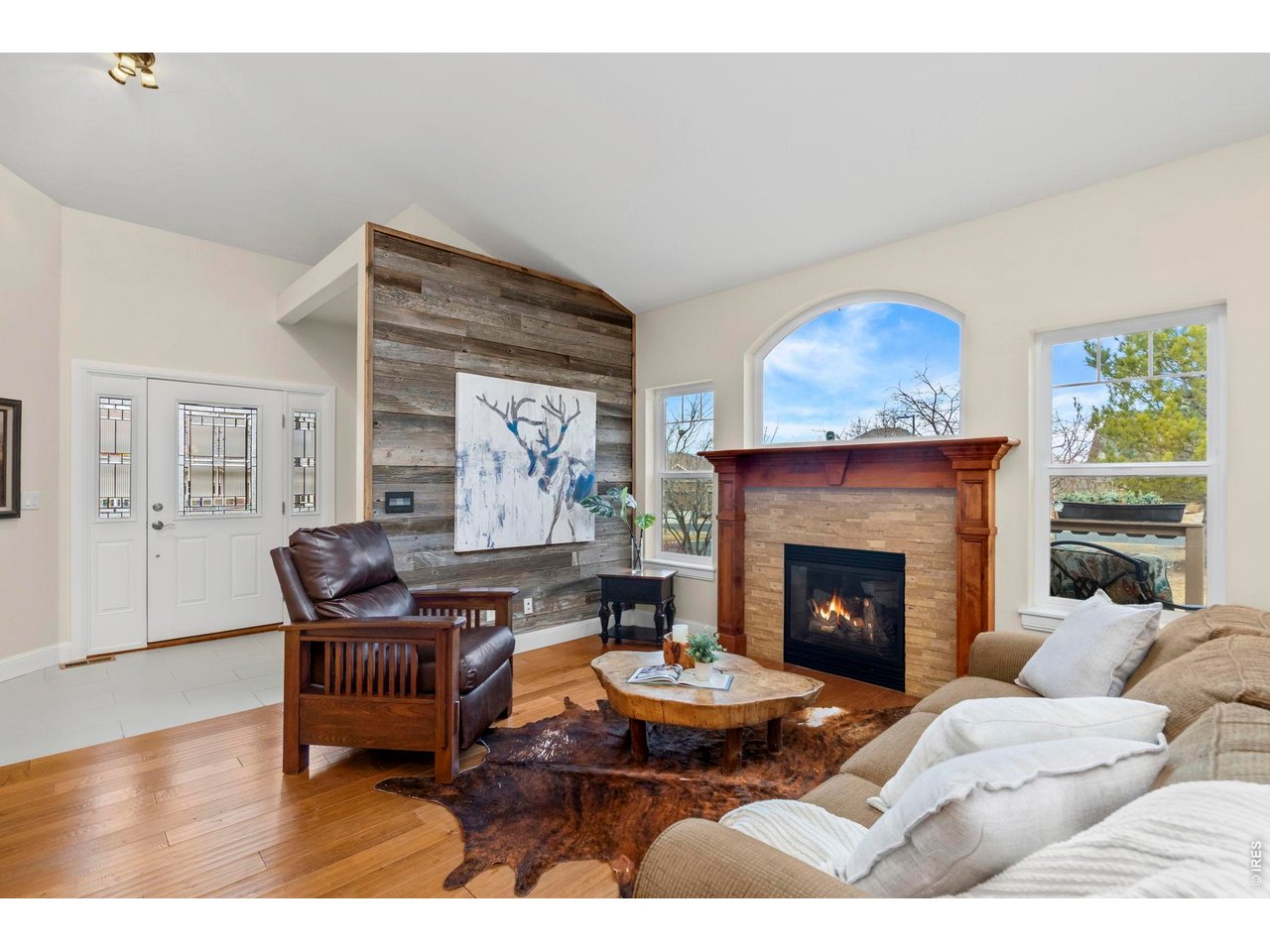 Property Photo 2 Living Room with views of the foothills. Cozy fireplace, vaulted ceilings and mixed use entertainment space