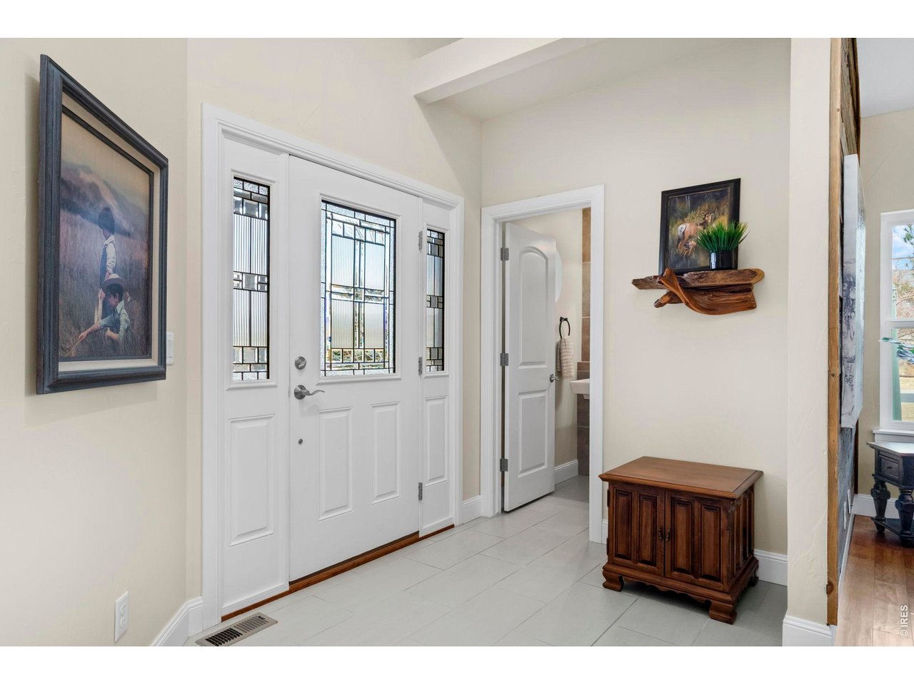Property Photo 22 The entryway is open and inviting. Off to the side, you will find an upgraded powder bath that is conveniently tucked away.