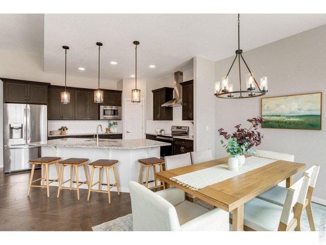 Property Photo 11 All stainless steel appliances, large hood, built-in microwave. Walk-in pantry & timless subway backsplash.
