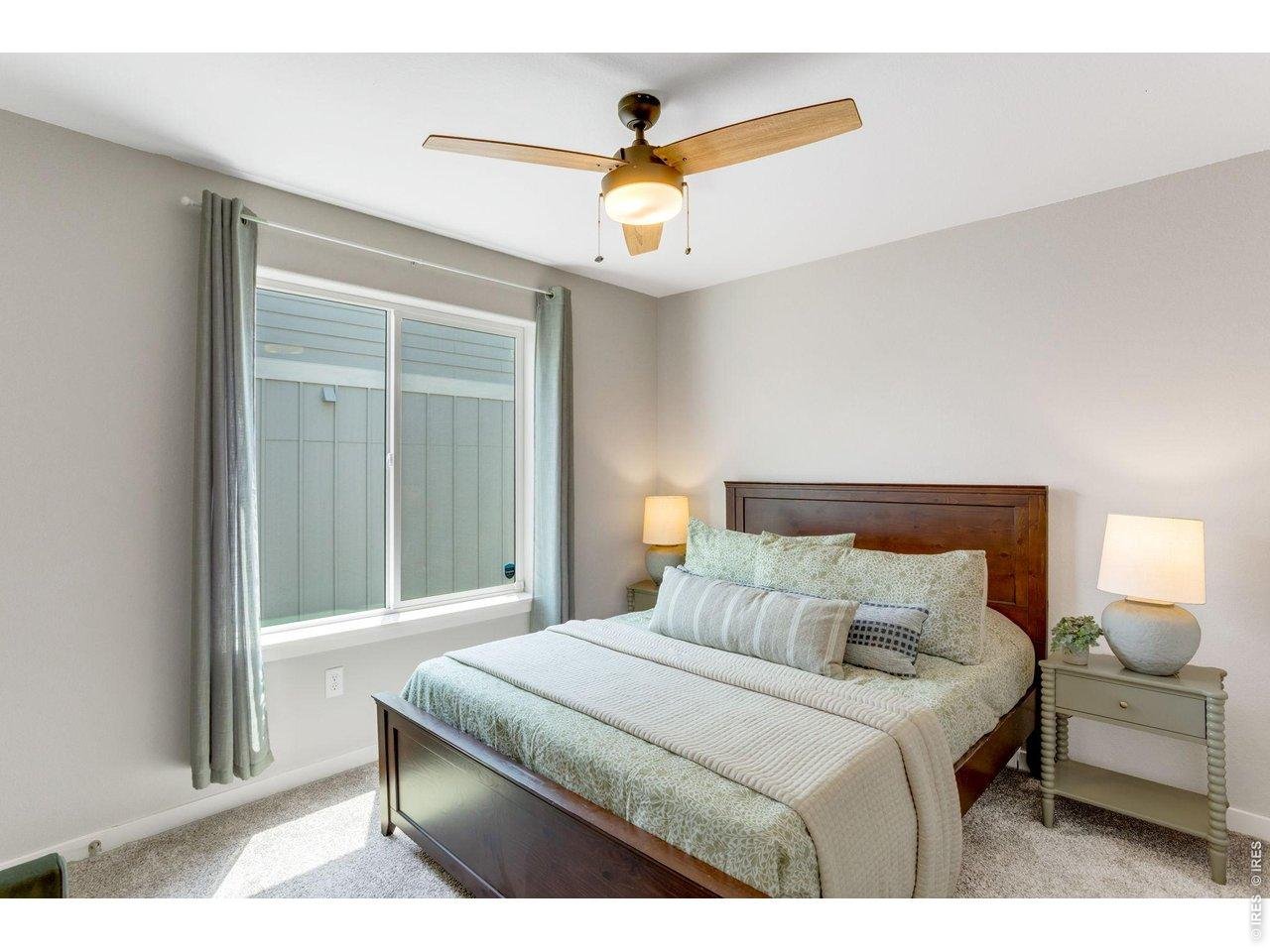 Property Photo 24 Secondary Bedroom on the main level, large picture windows, all window treatments included and all bedrooms on the main level have ceiling fans.