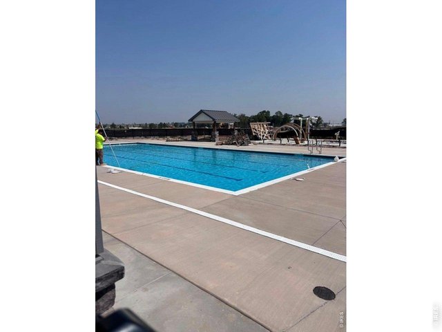 Property Photo 6 Open Summer 2027, Featuring an expansive community outdoor pool, a splash pad, shade pergolas, a clubhouse facility, and lounge!