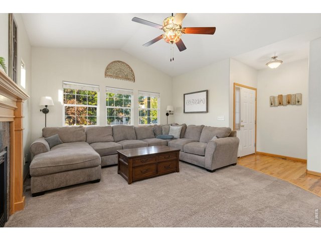 Property Photo 4 Spacious living room off front entry with ceiling fan.