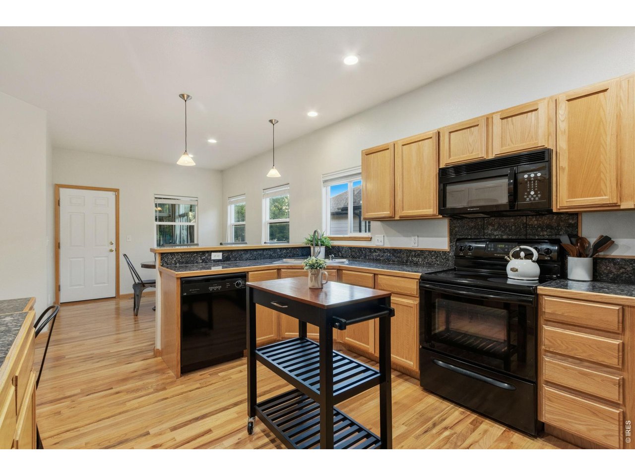Property Photo 8 Oak wood floors run from front entry into kitchen and down hallways to the bedrooms.