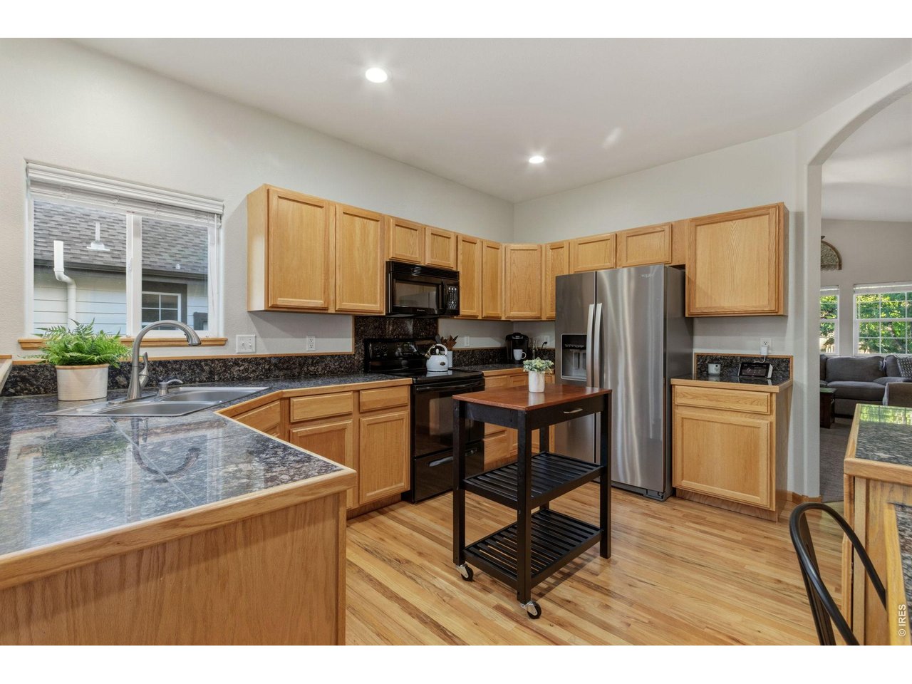 Property Photo 9 Tiled granite countertops, oak cabinets, and a new SS fridge in kitchen.