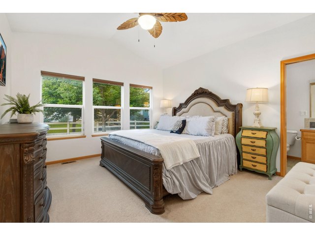Property Photo 14 Primary suite with vaulted ceiling and fan located at the back of the home (14 x 13).