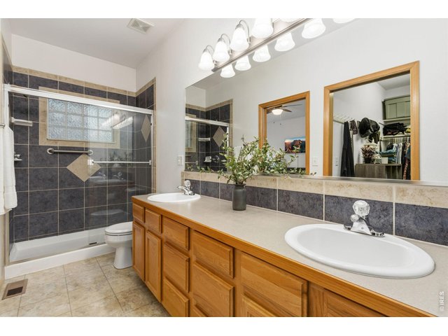 Property Photo 15 Primary bathroom features dual sinks with oversized, tiled shower.