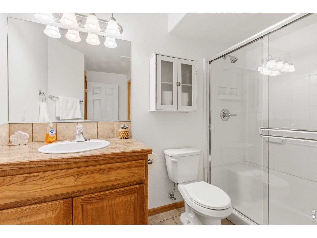 Property Photo 24 Basement 3/4 bath with tiled flooring and shower insert.