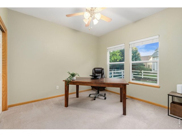 Property Photo 18 Secondary bedroom with ceiling fan looks into backyard (11 x 11).