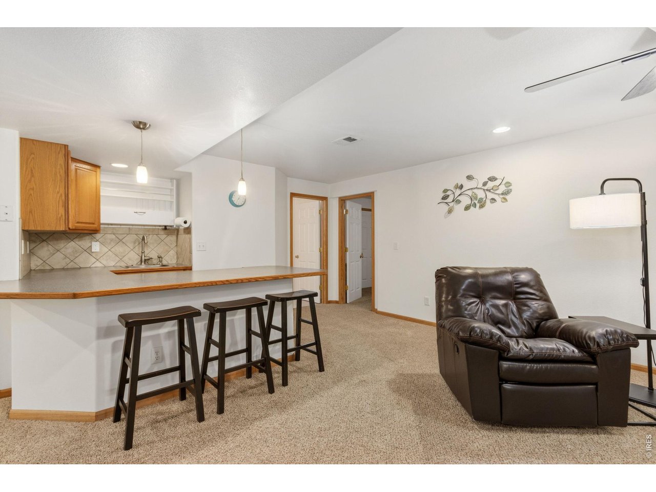 Property Photo 22 Basement bar area offers sink with bar fridge and full size refrigerator both included.
