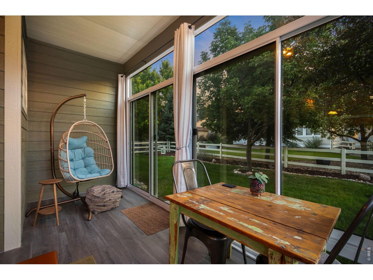 Property Photo 13 Sunroom offers floor to ceiling windows with lvp flooring and access to the back yard.