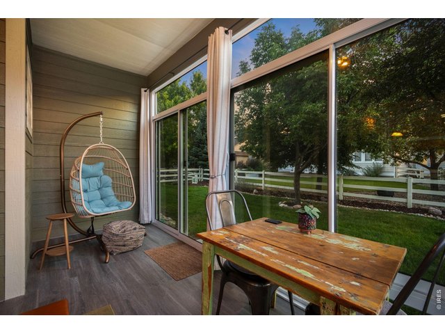 Property Photo 13 Sunroom offers floor to ceiling windows with lvp flooring and access to the back yard.