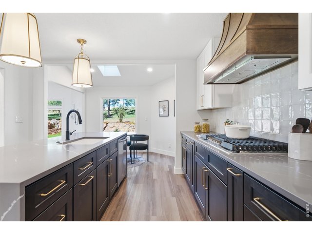 Property Photo 11 Two tone cabinets and a stunning hood give this kitchen that modern and chic look.