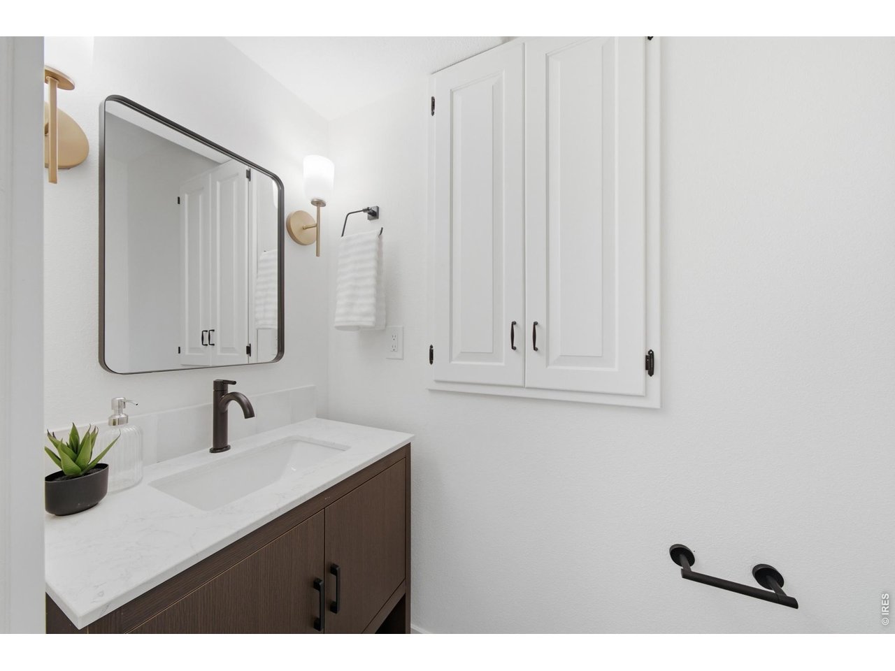 Property Photo 25 Half bath on the main level has been fully redone, while keeping some of it's original charm with built-in cabinets.