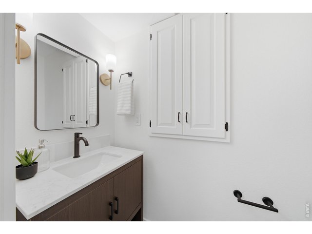 Property Photo 25 Half bath on the main level has been fully redone, while keeping some of it's original charm with built-in cabinets.