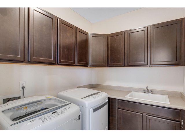 Property Photo 26 Upstairs laundry for convenience. Plenty of cabinets plus a utility sink