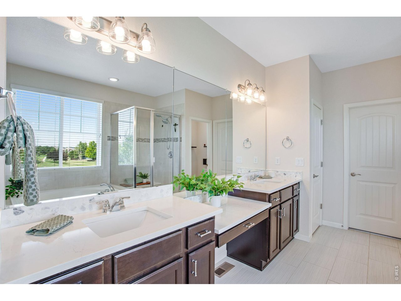 Property Photo 32 Primary bedrooms 5-piece luxury bath featuring granite slab countertop with 2 lifted vanities, soaking tub, tile flooring, linen closet, door to throne and a walk-in closet with a window