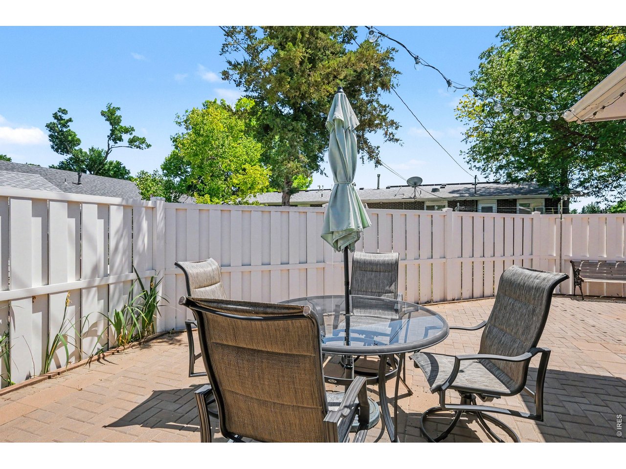 Property Photo 20 Paver Patio featuring bistro lighting, fenced yard and space to store toys.
