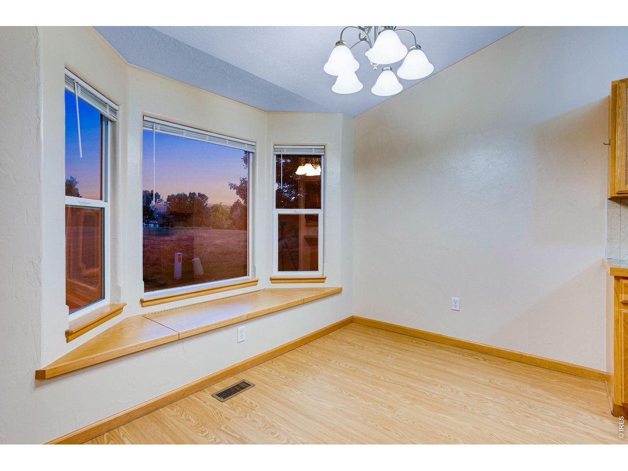 Property Photo 13 Dining area with bay window, sitting bench with storage and a chandelier