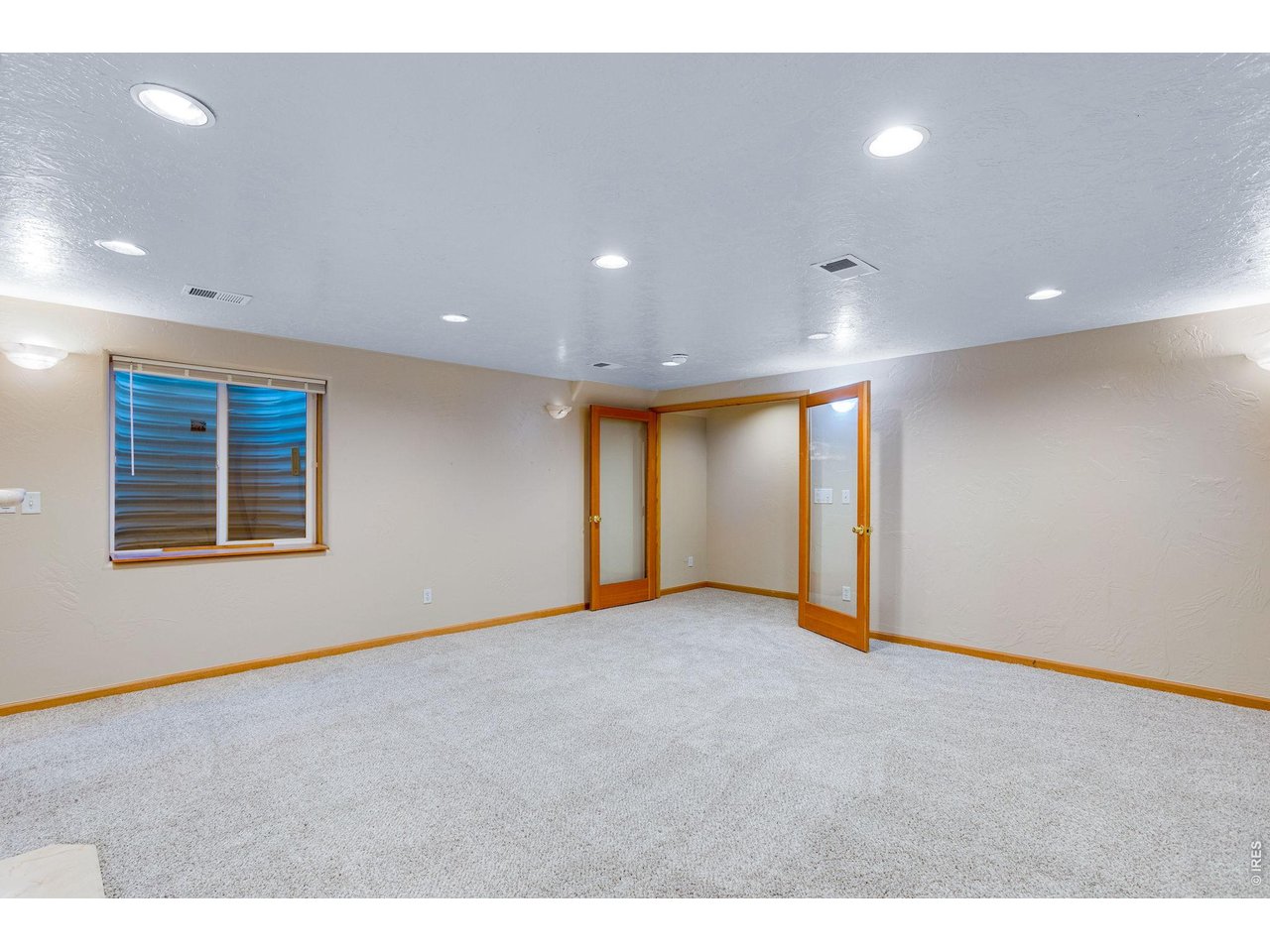 Property Photo 34 French doors lead you to a large and open family room featuring a 3rd gas fireplace, linen/game closet, built-in shelving, and 9 can lights on dimmer