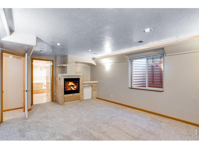 Property Photo 37 Guest suite or in-law quarters featuring a walk-in closet, 4th gas fireplace, and a 6-piece luxury bath