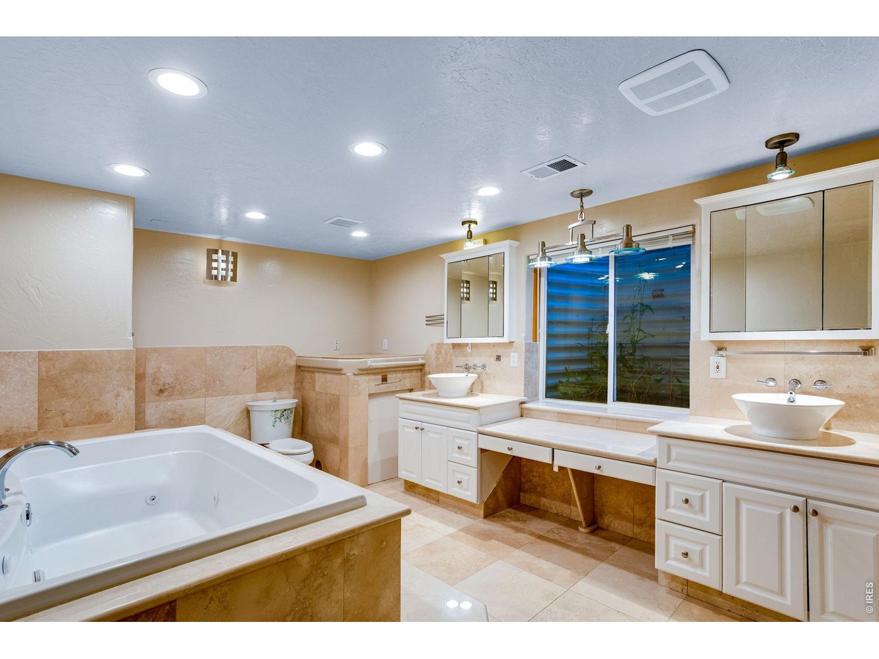 Property Photo 38 Private spa featuring a soaking jetted tub, 2 vessel sinks, 2 medicine cabinets, toilet, bidet, and a steam shower with many jets