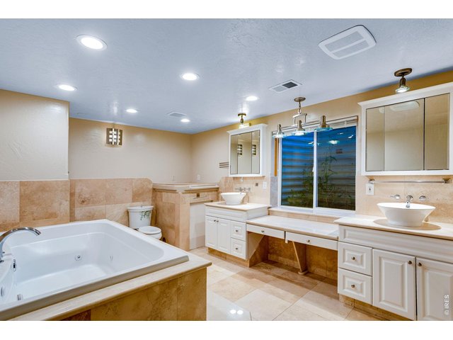 Property Photo 38 Private spa featuring a soaking jetted tub, 2 vessel sinks, 2 medicine cabinets, toilet, bidet, and a steam shower with many jets