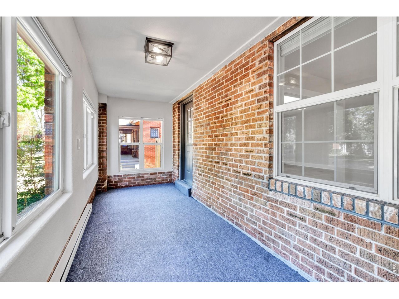 Property Photo 4 Enclosed heated front Porch with plenty of windows for natural light.