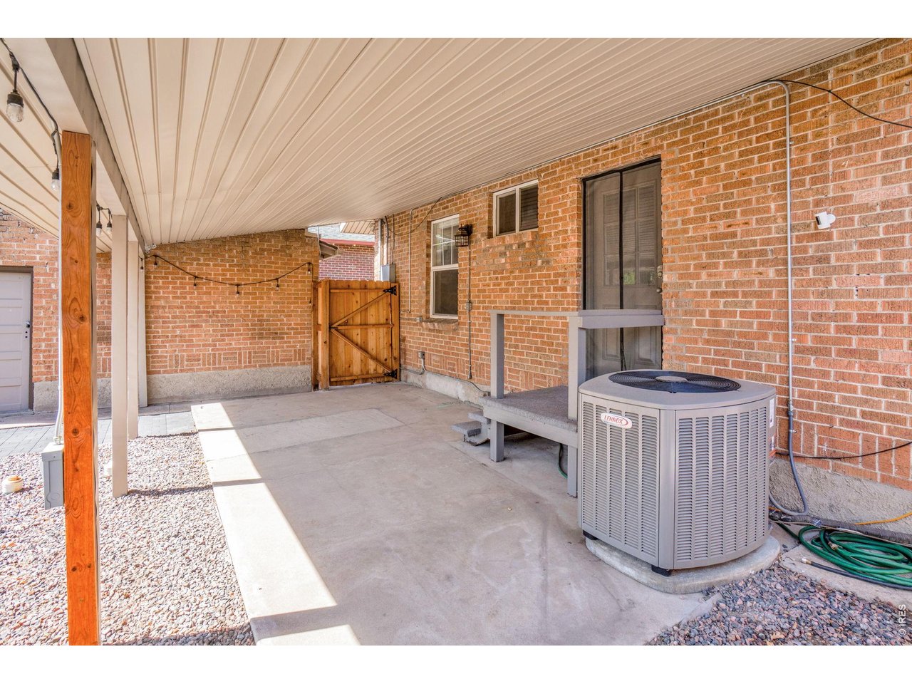 Property Photo 33 Covered back patio with outdoor lighting already in place, creating the perfect setting to relax and enjoy those summer nights.