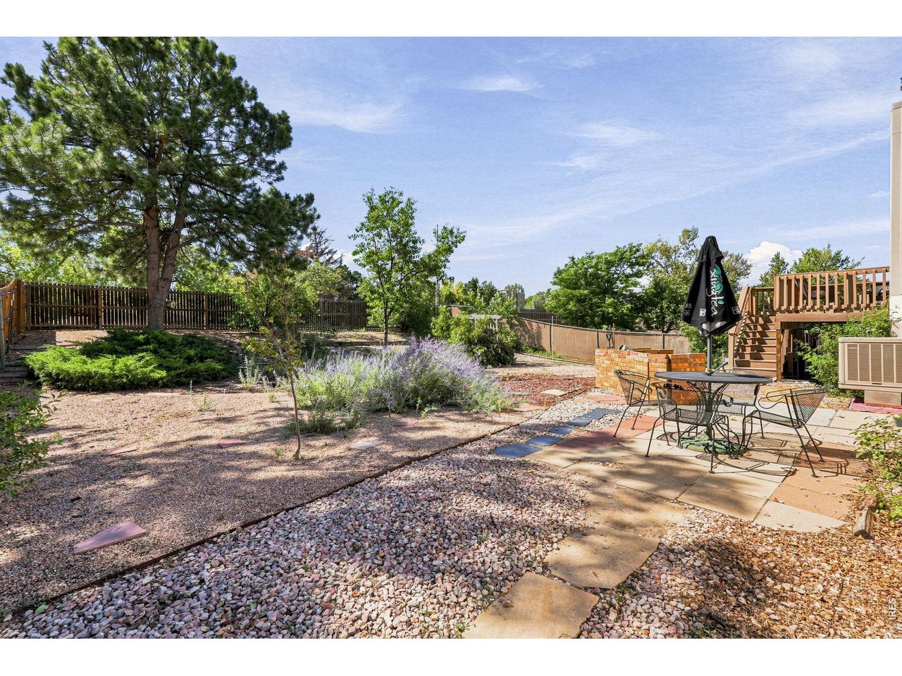Property Photo 41 Expansive backyard features a Trex deck, patio, fruit trees, and grapevines, providing plenty of room for outdoor enjoyment and gardening