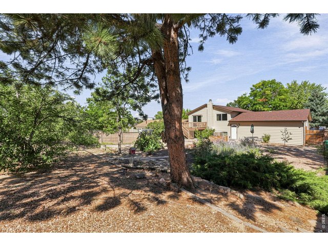 Property Photo 42 Expansive backyard features a Trex deck, patio, fruit trees, and grapevines, providing plenty of room for outdoor enjoyment and gardening