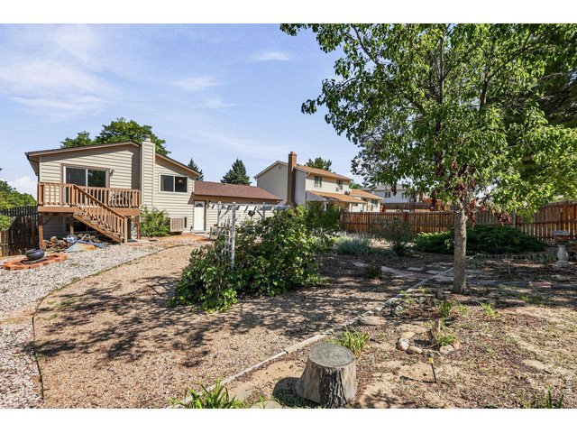 Property Photo 43 Expansive backyard features a Trex deck, patio, fruit trees, and grapevines, providing plenty of room for outdoor enjoyment and gardening
