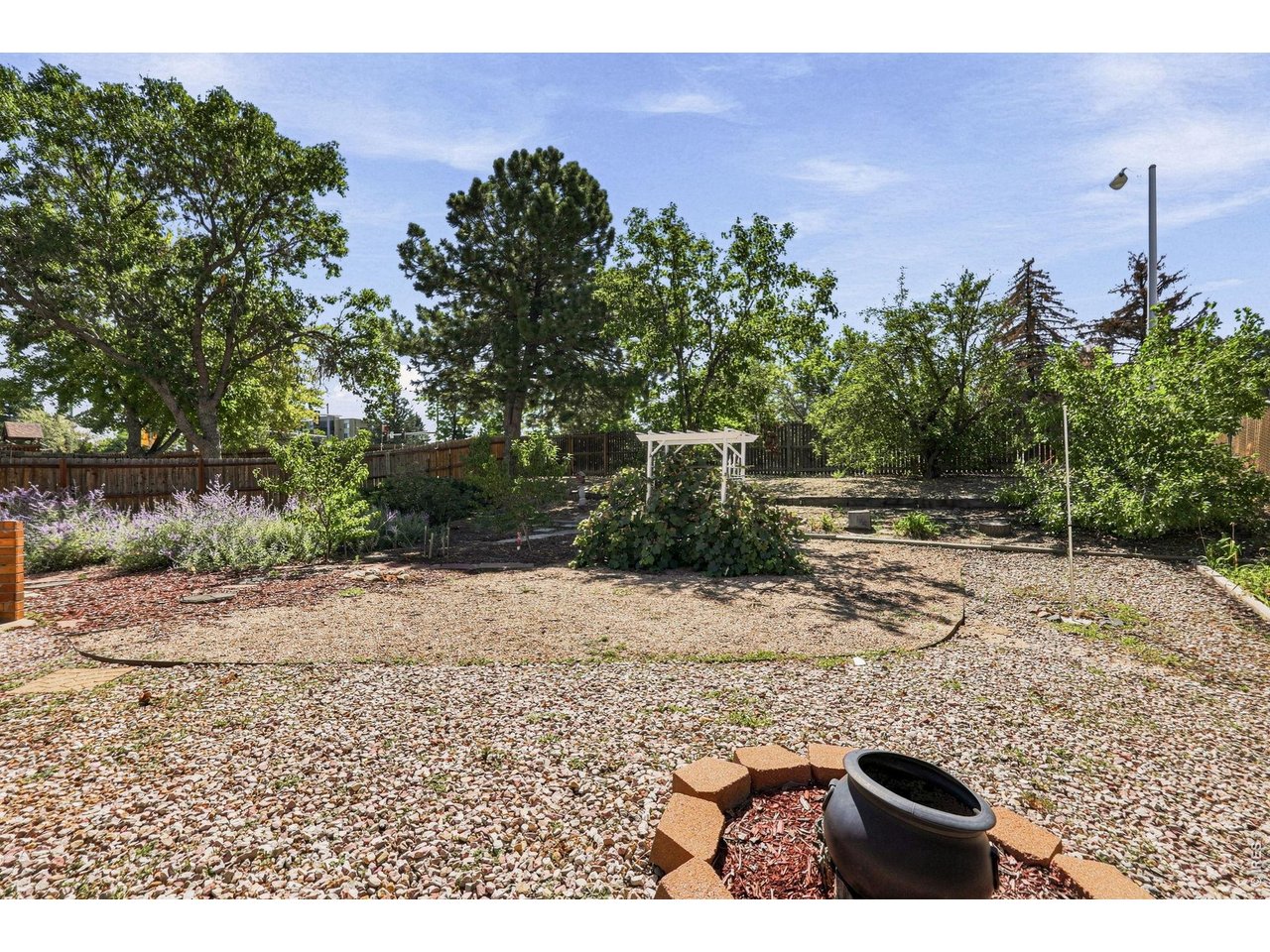 Property Photo 44 Expansive backyard features a Trex deck, patio, fruit trees, and grapevines, providing plenty of room for outdoor enjoyment and gardening