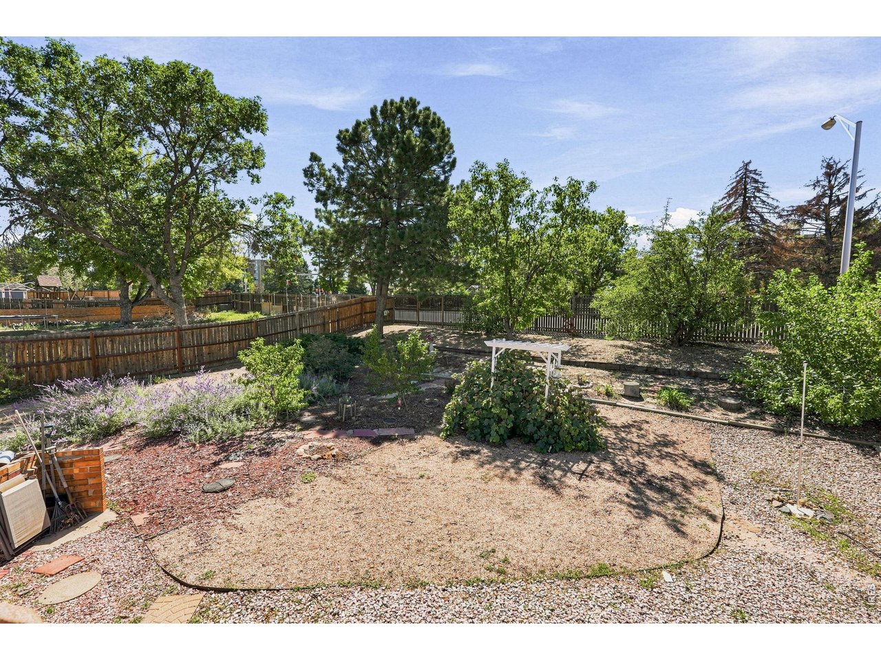 Property Photo 45 Expansive backyard features a Trex deck, patio, fruit trees, and grapevines, providing plenty of room for outdoor enjoyment and gardening