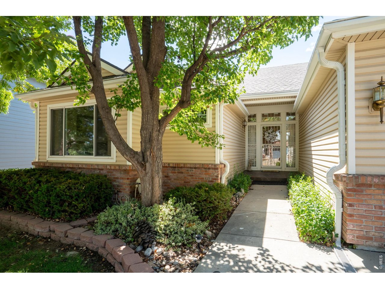 Property Photo 4 Updated landscaping and storm door for natural light and safety.