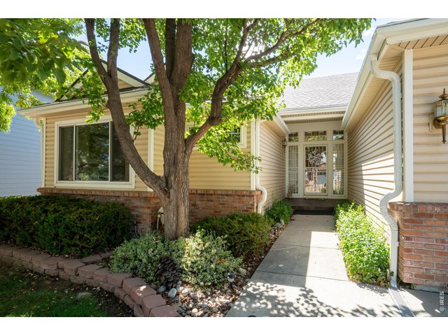 Property Photo 4 Updated landscaping and storm door for natural light and safety.