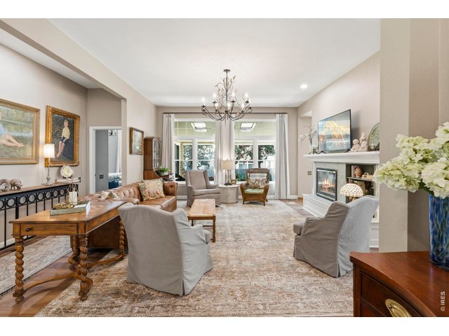 Property Photo 7 Living room with large windows and custom lighting.