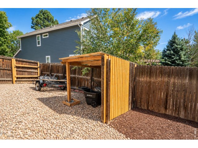 Property Photo 43 Extra wide gate allowing for storage of toys, plus covered area for lawn equipment.