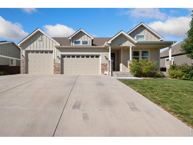 Property Photo 1 Craftsman Style Home, four car garage, 9 Foot 8 inch Third door opening, with tandem fourth car, xeriscaped backyard.